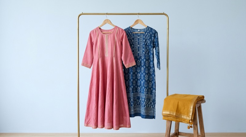 Rose anarkali and indigo block-print kurta on a clothes rail